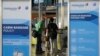 Travelers check in at a Malaysia Airlines counter at Kuala Lumpur International Airport in Sepang, Malaysia, July 18, 2014.