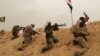 Fighters from Badr Brigades Shiite militia clash with Islamic State group militants at the front line on the outskirts of Fallujah, Anbar province, Iraq, June 1, 2015. 