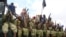 FILE - Al-Shabab fighters sit on a truck as they patrol in Mogadishu, Somalia,Oct. 30, 2009.