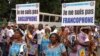 FILE - Demonstrators carry banners as they take part in a march voicing their opposition to independence or more autonomy for the Anglophone regions, in Douala, Cameroon Oct. 1, 2017.