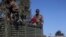 FILE - Ethiopian soldiers ride on a truck near the town of Adigrat, Tigray region, Ethiopia, March 18, 2021.