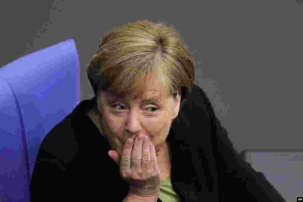 German Chancellor Angela Merkel talks with Vice Chancellor and Foreign Minister Sigmar Gabriel, after the German parliament Bundestag commemorated late former Chancellor Helmut Kohl, at the Reichstag building in Berlin.