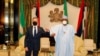 In this photo released by the Nigeria State House, U.S. Secretary of State Antony Blinken, left, is welcomed by Nigeria's President Muhammadu Buhari, right, before a meeting at the Presidential palace in Abuja, Nigeria, Nov. 18, 2021. 