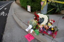FILE - A makeshift memorial was placed by a light pole a block away from a shooting where one person was killed at the Congregation Chabad synagogue in Poway, north of San Diego, Calif., April 27, 2019.