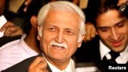 FILE - Farhatullah Babar speaks to the media outside the supreme court building in Islamabad, Dec. 16, 2009.