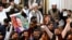Supporters of jailed former prime minister Imran Khan's Pakistan Tehreek-e-Insaf party show portraits of Khan during an oath-taking ceremony of newly elected members at the provincial legislature of Pakistan's Khyber Pakhtunkhwa Assembly in Peshawar on Feb. 28, 2024. 