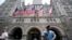 FILE - Law enforcement officers stand guard in front of the Trump Hotel in Washington, June 30, 2018.