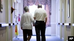 FILE - In this Nov. 6, 2015 file photo, an elderly couple walks down a hall of a nursing home in Easton, Pennsylvania. (AP Photo)