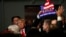 Republican presidential candidate, businessman Donald Trump, holds one of his signs after a rally coinciding with Pearl Harbor Day at Patriots Point aboard the aircraft carrier USS Yorktown in Mt. Pleasant, S.C., Monday, Dec. 7, 2015.