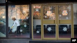 FILE - In this Feb. 17, 2016 photo, a worker sweeps the floor inside a branch of the North Korean-operated Haedanghwa restaurant in Beijing. Chinese news reports, Sept. 28, 2017, say the government has ordered most North Korean-owned businesses and ventures with Chinese partners to close under U.N. sanctions imposed over the North's nuclear and missile programs. 