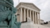 A police officer walks outside the Supreme Court on Capitol Hill in Washington, Monday, July 6, 2020. (AP Photo/Patrick Semansky)