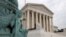 A police officer walks outside the Supreme Court on Capitol Hill in Washington, Monday, July 6, 2020. (AP Photo/Patrick Semansky)