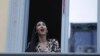 Opera singer Laura Baldassari leans out of her window to sing during a flash mob launched throughout Italy to bring people together and try to cope with the emergency of coronavirus, in Milan, Italy, March 13, 2020.