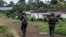 FILE - A Cameroonian policeman and a gendarme patrol in Lysoka, near Buea, in Cameroon's Anglophone South-West region, October 07, 2018.