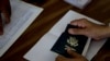 FILE - A person holds a U.S. passport at a reporting center in Islamabad, Pakistan, July 29, 2010. The U.S. Justice Department announced on Wednesday that it has set up a new office tasked with handling denaturalizations.