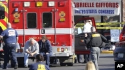 Emergency personnel work at the scene where Rep. Gabrielle Giffords, D-Ariz., and others were shot outside a Safeway grocery store in Tucson, Ariz. on Saturday, Jan. 8, 2011.