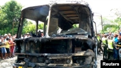 The charred remains of a bus, in which 31 children died, is seen in Fundacion, northern Colombia, May 18, 2014.