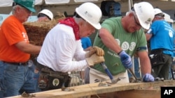 Former President Jimmy Carter, center, works on a Habitat for Humanity construction project in Memphis, Tennessee, Aug. 22, 2016.