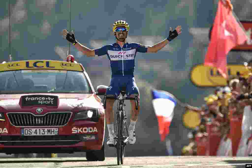 France&#39;s Julian Alaphilippe celebrates as he crosses the finish line to win the 10th stage between Annecy and Le Grand-Bornand, French Alps, of the 105th edition of the Tour de France cycling race.