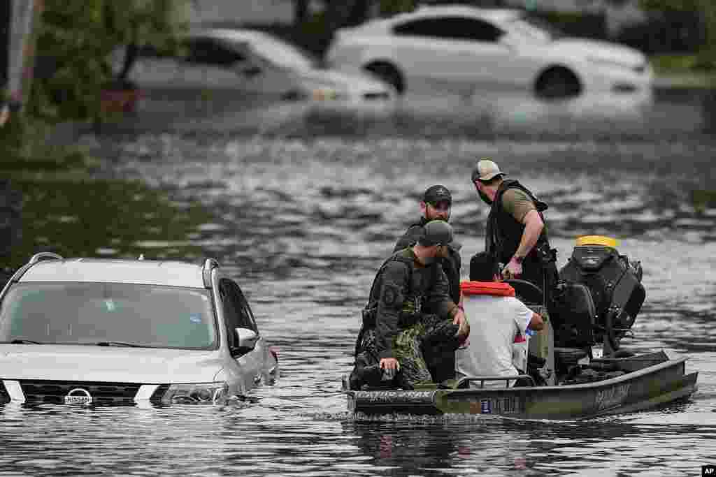 People are rescued from an apartment complex in the aftermath of Hurricane Milton, in Clearwater, Florida, Oct. 10, 2024.