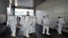 Workers from a disinfection service company sanitize a branch of the Shincheonji Church of Jesus the Temple of the Tabernacle of the Testimony where a woman known as "Patient 31" attended a service in Daegu, South Korea, February 19, 2020. Yonhap…