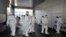 Workers from a disinfection service company sanitize a branch of the Shincheonji Church of Jesus the Temple of the Tabernacle of the Testimony where a woman known as "Patient 31" attended a service in Daegu, South Korea, February 19, 2020. Yonhap…
