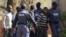 Police keep watch during the arrival of some of the 250 mine workers who were arrested when they had a shoot out with police, at a Garankuwa court outside Pretoria, South Africa, August 20, 2012. 