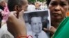 Mourners hold a portrait of Cambodian government critic Kem Ley during a funeral ceremony in Phnom Penh, Cambodia, Wednesday, July 13, 2016. 