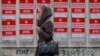 A girl walks by campaign posters for socialist presidential candidate Igor Dodon, in Chisinau, Moldova, Nov. 12, 2016. 
