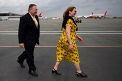 U.S. Secretary of State Mike Pompeo and his wife Susan Pompeo walk on the tarmac before departure at Luanda International Airport in Luanda, Angola, Feb. 17, 2020.