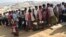 FILE - Rohingya refugees stand in a queue to collect aid supplies in Kutupalong refugee camp in Cox's Bazar, Bangladesh, Jan. 21, 2018.