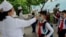 FILE - Kim Song Ju Primary School students have their temperatures checked in Pyongyang, North Korea, June 3, 2020. After months of denying it had any coronavirus infections, North Korea reported its first suspected case July 25, 2020.