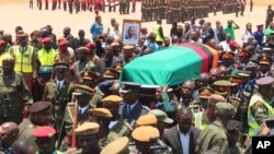 Members of the Zambian Defence Forces and other government officials attend a ceremony to welcome the body of former Zambian President Michael Sata at Kenneth Kaunda International Airport in Lusaka, Nov.1, 2014.
