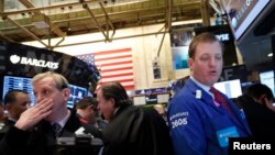 Traders work on the floor of the New York Stock Exchange March 5, 2013. The Dow surged to a new record on Tuesday, breaking through levels last seen in 2007 as investors extended 2013's rally. 