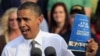 President Barack Obama holds up a copy of jobs plan during a joint campaign appearance with Vice President Joe Biden (not seen) at Triangle Park in Dayton, Ohio, October 23, 2012.