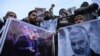Protesters shout slogans against the United States and Israel as they hold posters with the image of top Iranian commander Qasem Soleimani, who was killed in a US airstrike in Iraq, and Iranian President Hassan Rouhani during a demonstration in the…
