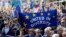 Anti Brexit campaigners carry flags and banners as they march towards Britain's parliament in London, March 25, 2017. Britain's Prime Minister Theresa May is expected to start the process of leaving the European Union March 29. 