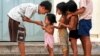 FILE - Cambodian orphans play together as they wait for adoption at an orphanage in Phnom Penh, June 22, 2000. 