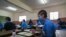 Students wear face masks as a preventive measure against the spread of the COVID-19 coronavirus in their classroom at the Jean Benoit College in Yaoundé, Cameroon, on June 1, 2020. 