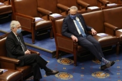 FILE - Then-Senate Majority Leader Mitch McConnell, left, and Senate Democratic Leader Chuck Schumer are seen during a joint session of Congress in the House chamber in Washington, Jan. 6, 2021.