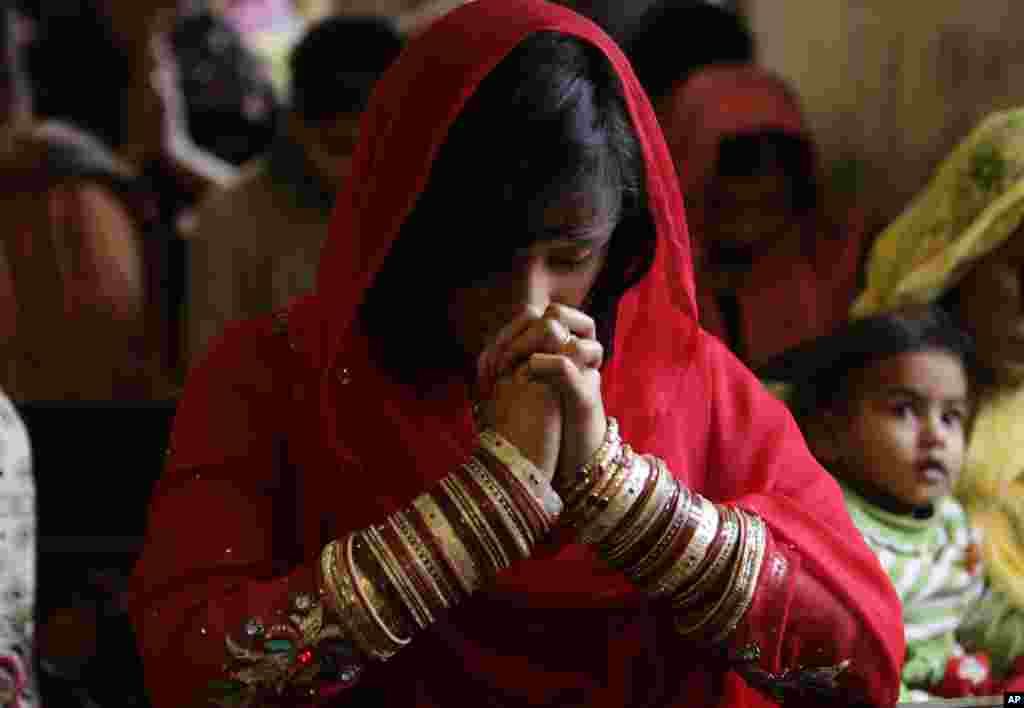 Pakistani Christians attend a prayer service on the first day of the new year at a local church in Lahore, Pakistan, Jan. 1, 2014. 