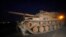 A Turkish army tank is driven to its new position on the Turkish side of the border between Turkey and Syria, in Sanliurfa province, southeastern Turkey, Oct. 8, 2019. 