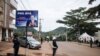 FILE - Police officers stand in front of the polling station where incumbent Cameroon President Paul Biya, is expected to vote, in Yaounde, Oct. 7, 2018. Biya's election win remain disputed by the opposition. 