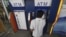A man uses an automated teller machine (ATM) machine at a shopping center in Yangon, Burma, May 27, 2012.