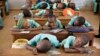 FILE - Muslim boys rest their heads on their desks during a language class at Al-Haramain madrassa at the Islamic Complex in Cameroon's capital Yaounde. Teachers, especially in the north, are afraid to return to their classrooms because of Boko Haram. 