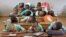 FILE - Boys rest their heads on their desks during a language class in Cameroon's capital, Yaounde. Strikes by teachers and lawyers to push for more use of English have turned violent, and schools have closed.