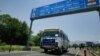 FILE - An Indian bus carrying passengers who arrived from the Pakistani side of Kashmir leaves the border at Chakka Da Bagh in Poonch district, 250 kilometers (156 miles) northwest of Jammu, India.