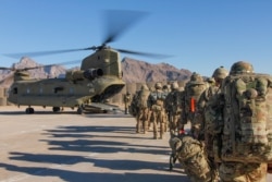 FILE - U.S. soldiers load onto a Chinook helicopter to head out on a mission in Afghanistan, Jan. 15, 2019.