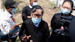 FILE - Khin Maung Zaw, center, speaks to journalists outside the Zabuthiri Township Court in Naypyitaw, Myanmar, March 1, 2021.