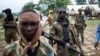 FILE - Seleka fighters stand in their base before a mission in the town of Lioto, Central African Republic, June 9, 2014.